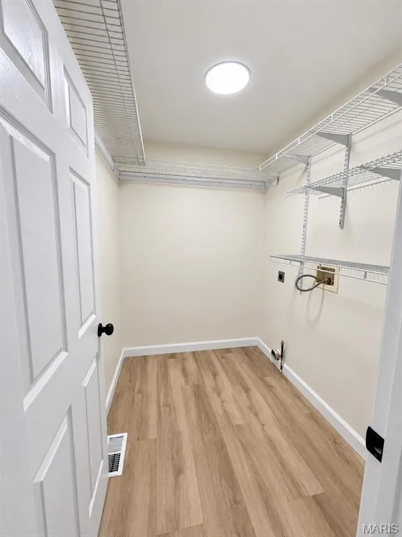 Wood-finish flooring, recessed ceiling light, wire shelving system, and paneled interior door — 1731 Fairview Farms Circle, Wentzville, MO 63385