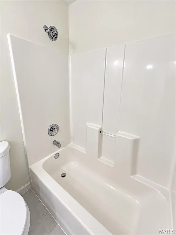Alcove bathtub with white surround, chrome showerhead, and matching chrome fixtures — 1731 Fairview Farms Circle, Wentzville, MO 63385