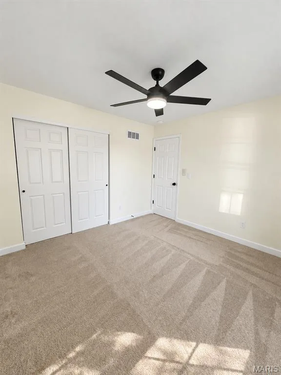 Recessed lighting, ceiling fan with integrated light, warm-toned carpeting, white interior doors, and neutral wall paint — 1731 Fairview Farms Circle, Wentzville, MO 63385