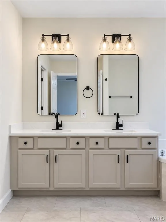 Dual vanity with white countertop, undermount sinks, and matte black fixtures — 1731 Fairview Farms Circle, Wentzville, MO 63385