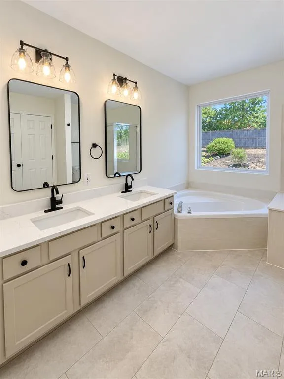 Dual vanity with integrated sinks, quartz-finish countertop, and matte black fixtures — 1731 Fairview Farms Circle, Wentzville, MO 63385