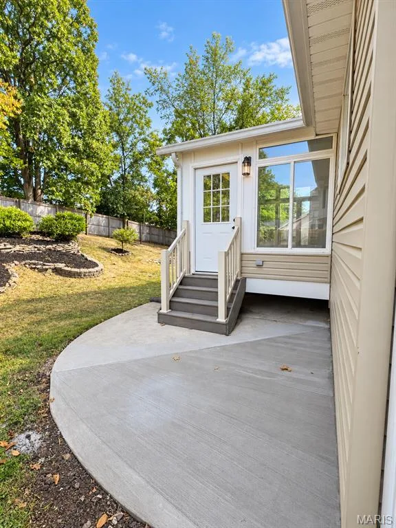 Sunroom access, concrete patio, fenced yard, and landscaped area — 1731 Fairview Farms Circle, Wentzville, MO 63385
