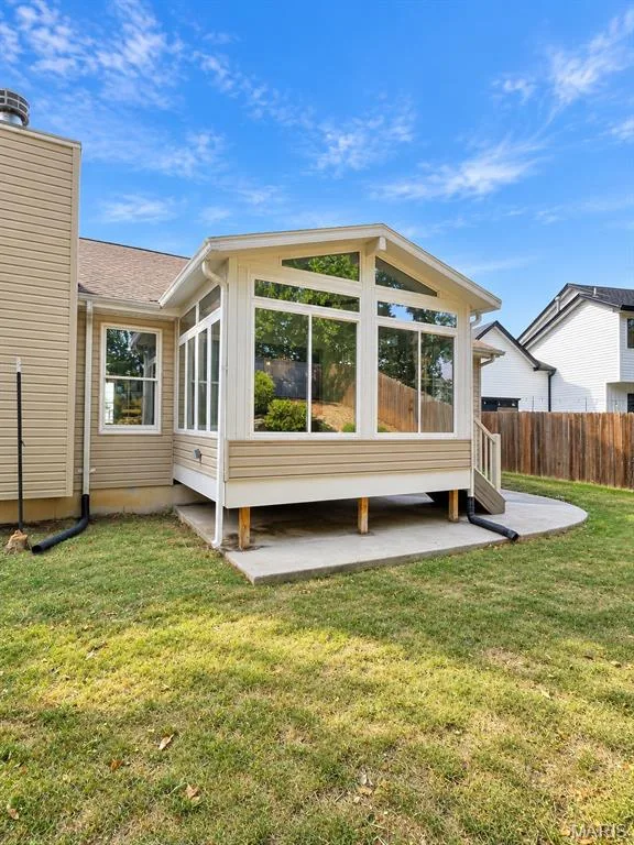 Sunroom addition featuring vaulted ceilings and extensive window panels — 1731 Fairview Farms Circle, Wentzville, MO 63385