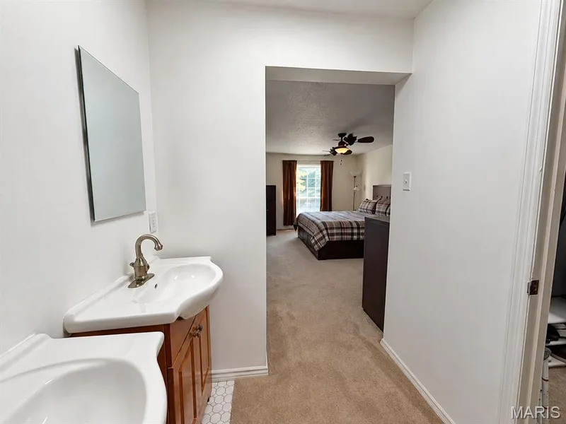 Corner vanity with a white ceramic sink and brushed nickel faucet — 15631 Hedgeford Court #9, Chesterfield, MO 63017