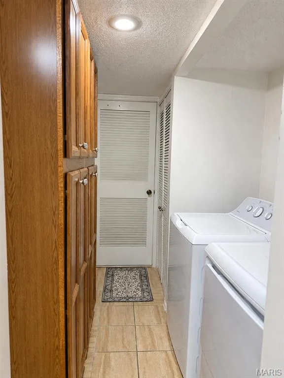 Extensive wood-finish cabinetry, recessed ceiling lighting, and tiled flooring — 15631 Hedgeford Court #9, Chesterfield, MO 63017