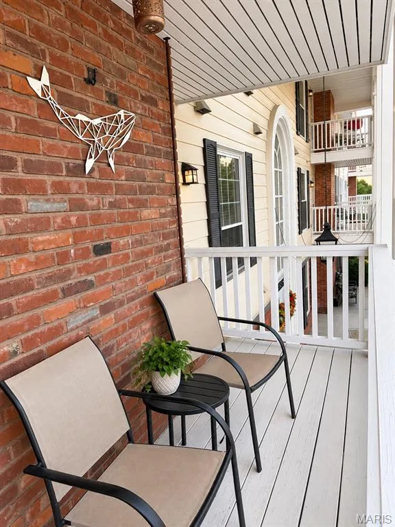 Brick exterior accent, white railing, arched window, exterior lighting fixtures, durable deck surface — 15631 Hedgeford Court #9, Chesterfield, MO 63017