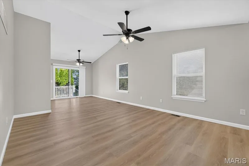 Reverse view from the living room shows the lighter vinyl plank flooring — 1540 Batters Box Drive, O'Fallon, MO 63366