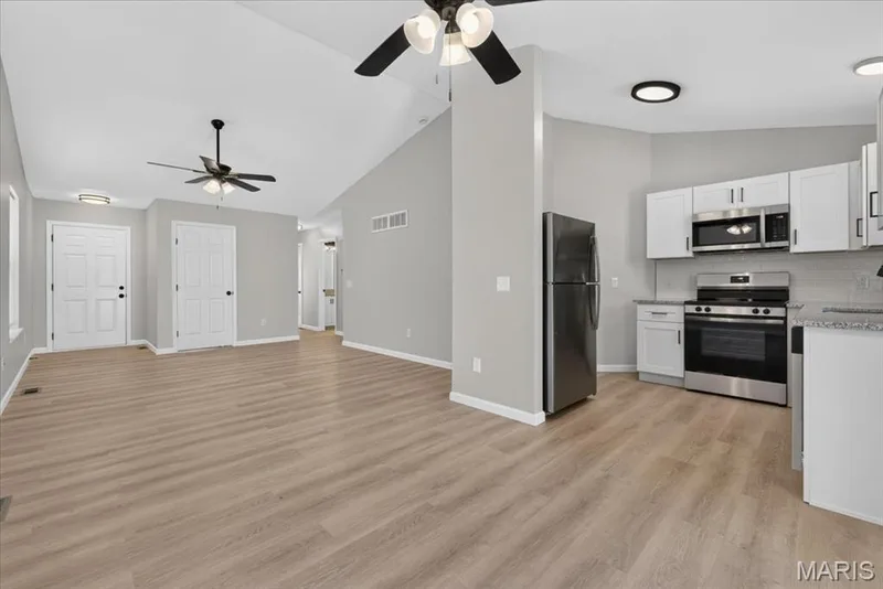 View from the breakfast area...door to the left of the frame is the entry, next is the lower level door and then central hallway — 1540 Batters Box Drive, O'Fallon, MO 63366