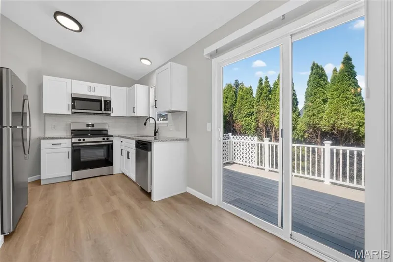 This view from breakfast area highlights the composite deck — 1540 Batters Box Drive, O'Fallon, MO 63366