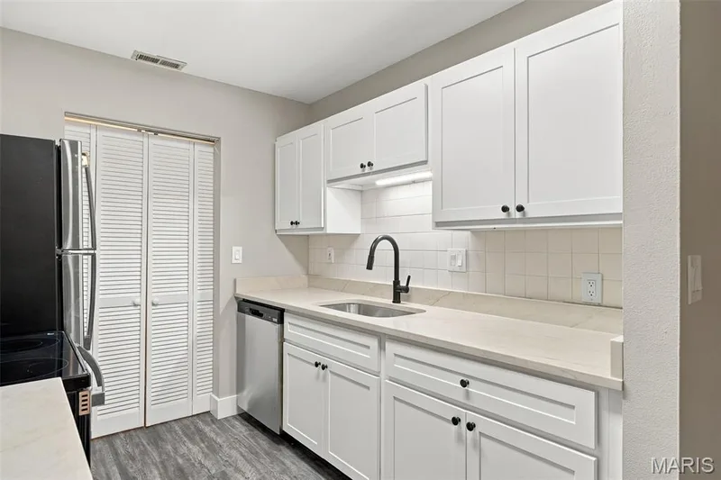Kitchen features new cabinets, new granite counter tops, and new appliances. — 2415 Sandalwood Creek Court #C, Wildwood, MO 63038