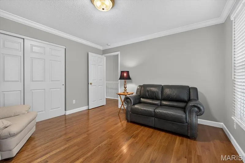 Main floor bedroom has hardwood floors — 2169 Farnsworth Drive #1424A, O'Fallon, MO 63368
