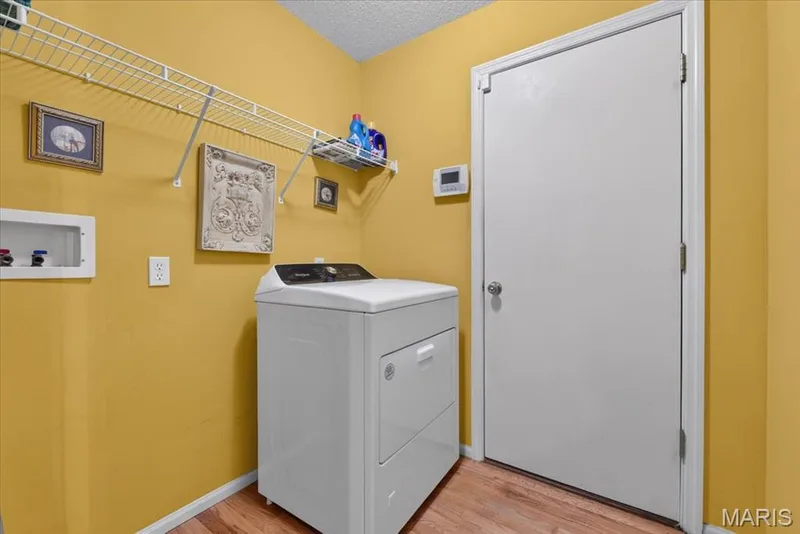 Main floor laundry opens to garage — 2169 Farnsworth Drive #1424A, O'Fallon, MO 63368