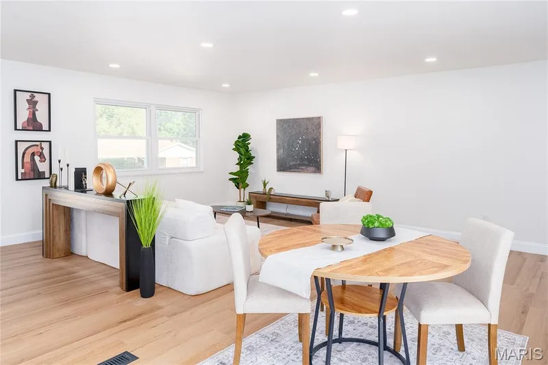 Bright living space featuring light wood-finish flooring, recessed lighting, and a double window — 3025 Sherwood Lane, St Charles, MO 63301