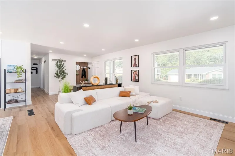 Recessed lighting illuminates the open living space with wood-finish flooring — 3025 Sherwood Lane, St Charles, MO 63301