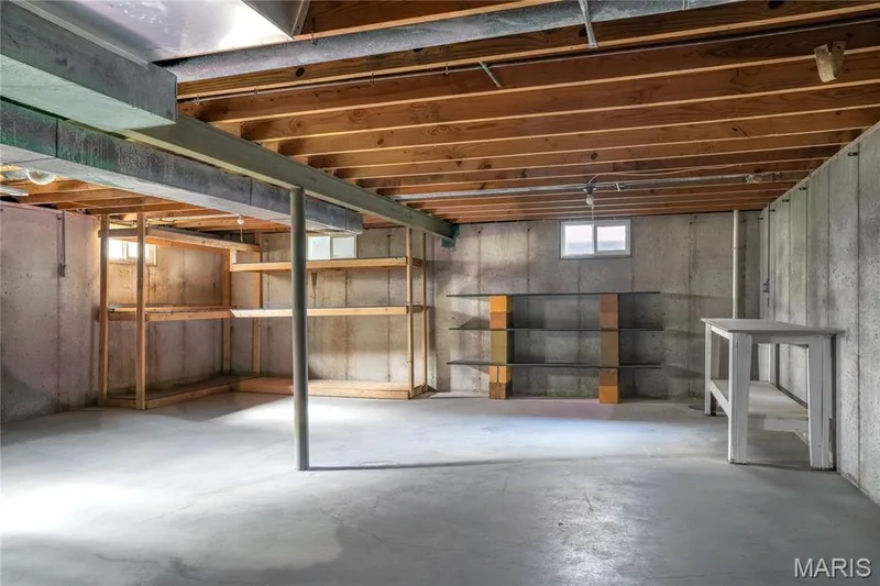 Unfinished basement with exposed wood joists, concrete walls, concrete flooring, and multiple windows — 3025 Sherwood Lane, St Charles, MO 63301