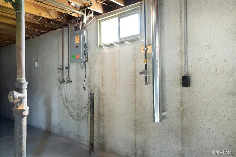 Concrete foundation wall with exposed ceiling joists and a utility window — 3025 Sherwood Lane, St Charles, MO 63301