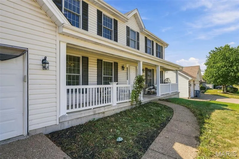 Two-story residence featuring light-colored siding and dark window shutters — 8 Jacobs Place Court, O'Fallon, MO 63376