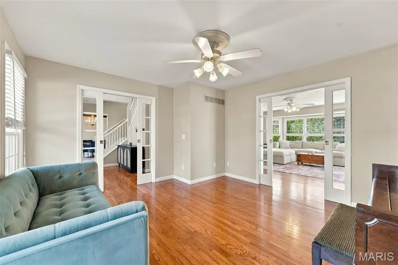 Hardwood flooring, painted walls, ceiling fan with integrated lighting, and white trim — 8 Jacobs Place Court, O'Fallon, MO 63376