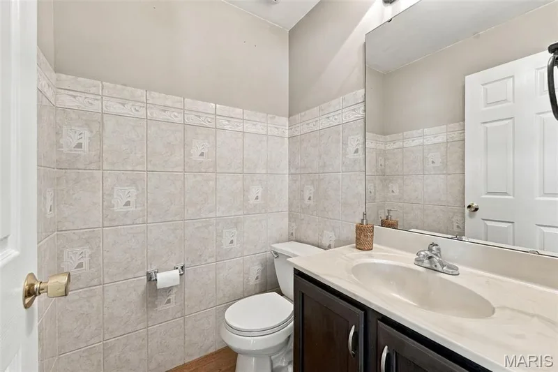 Tile wainscoting with decorative border accents — 8 Jacobs Place Court, O'Fallon, MO 63376