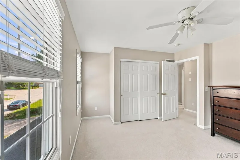 Recessed lighting, ceiling fan, twin windows with blinds, bi-fold closet doors, and light-toned carpeting — 8 Jacobs Place Court, O'Fallon, MO 63376