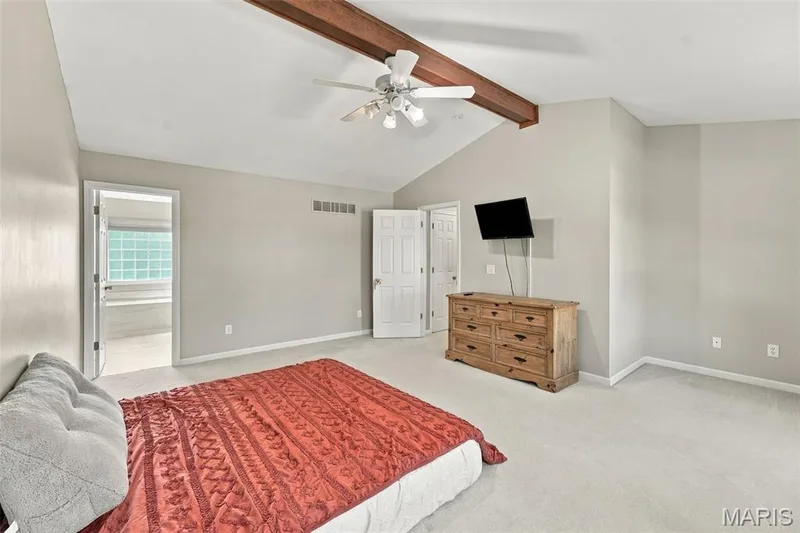 Vaulted ceiling featuring a wood-finish beam and ceiling fan — 8 Jacobs Place Court, O'Fallon, MO 63376