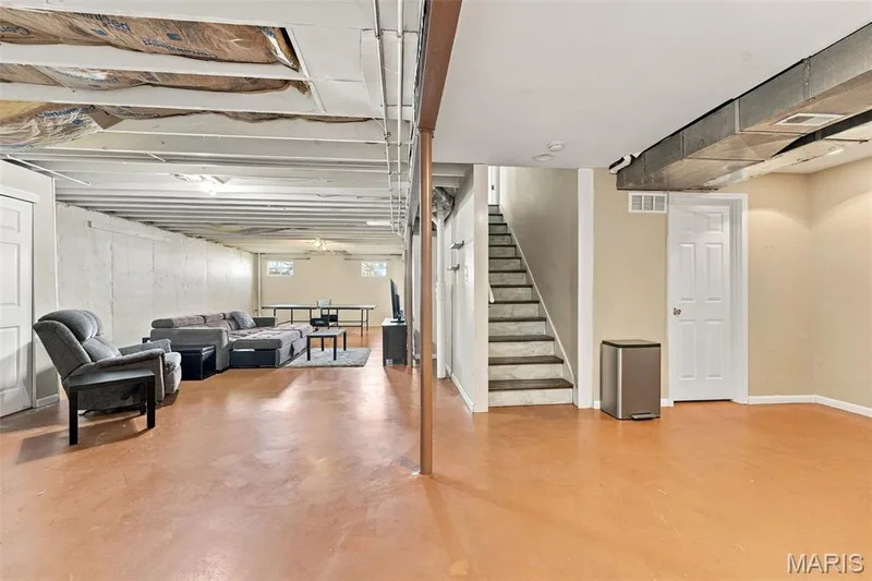 Expansive lower level with painted concrete flooring, exposed ceiling joists, and recessed lighting — 8 Jacobs Place Court, O'Fallon, MO 63376