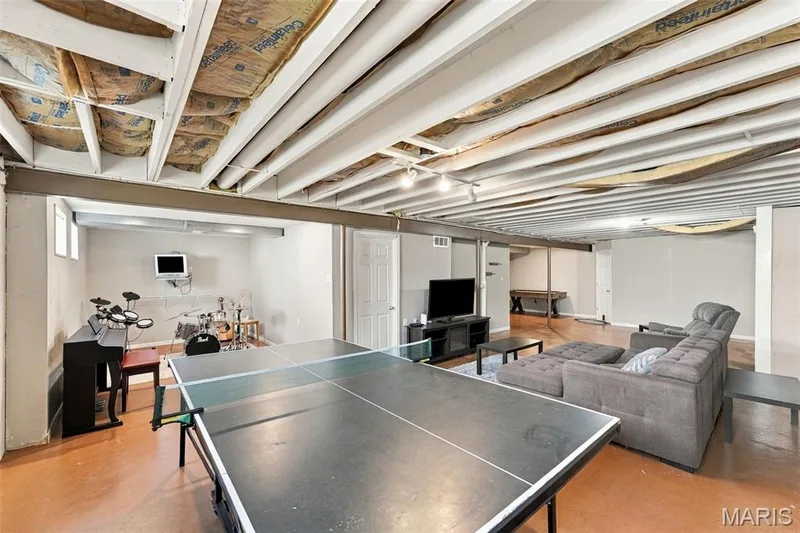 Expansive finished basement featuring exposed ceiling joists, recessed lighting, and durable flooring — 8 Jacobs Place Court, O'Fallon, MO 63376