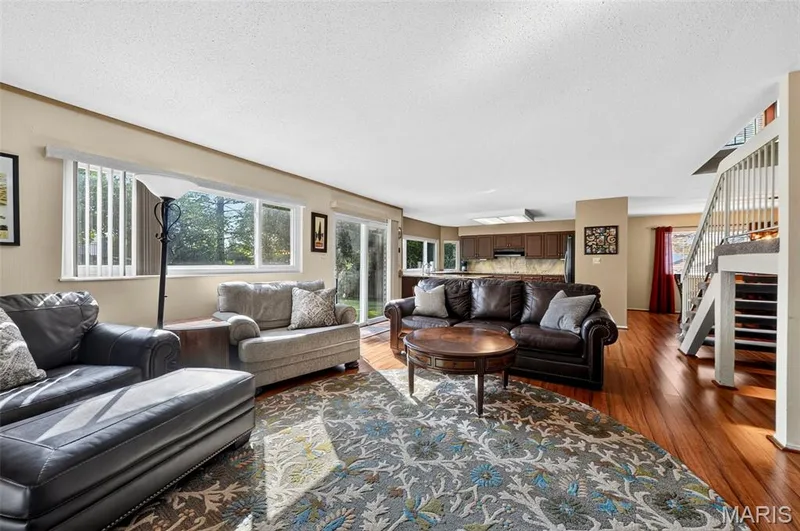 Large back living space with fireplace, wood floors, open to the kitchen & backyard access — 25 Vicksburg Station, St Charles, MO 63303