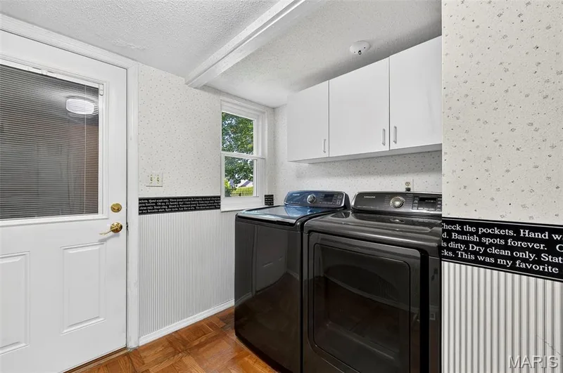 Nice sized laundry room with storage, garage access, & backyard access. — 25 Vicksburg Station, St Charles, MO 63303