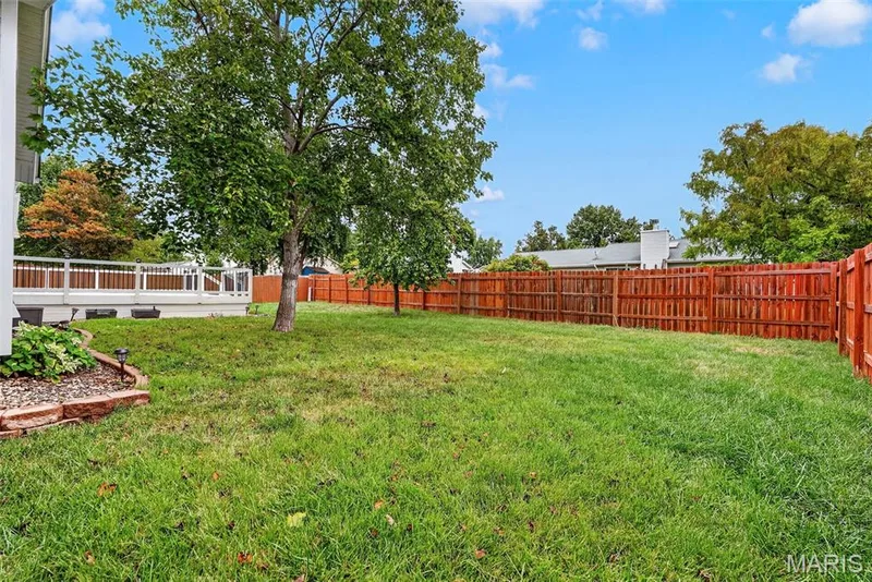 Newer cedar privacy fence encloses the flat backyard — 6401 Long Timber Drive, O'Fallon, MO 63368