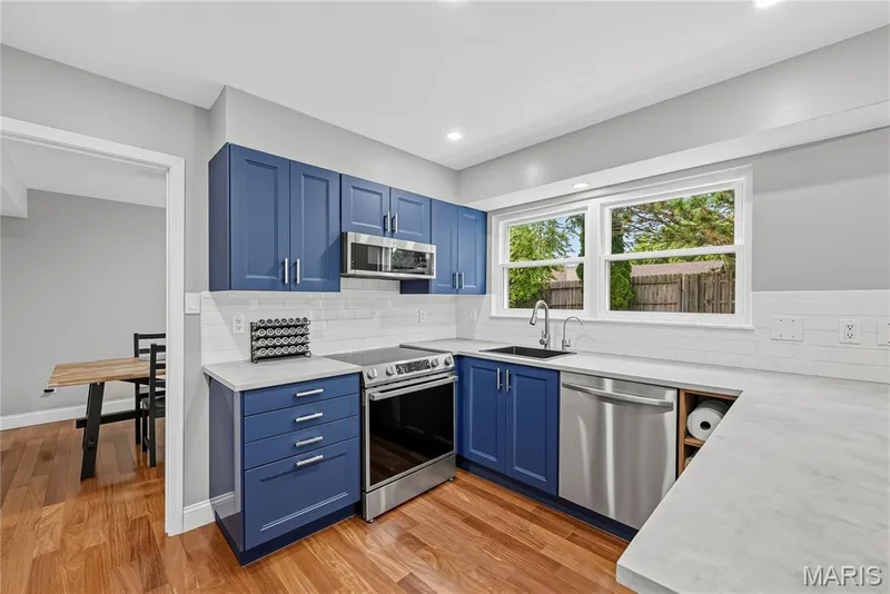 Kitchen with updated Cabinetry, Stainless Steel Appliances and Tile Backsplash — 1645 Wild Goose Run, St Charles, MO 63303