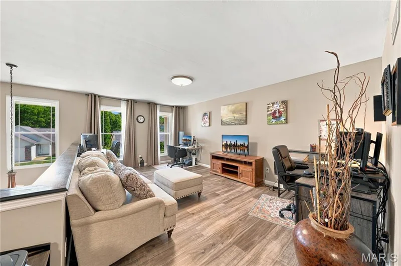 Three updated double hung windows, luxury vinyl plank flooring, ceiling light, open to below and neutral decor. — 1417 Plantation Manor Court, St Peters, MO 63303
