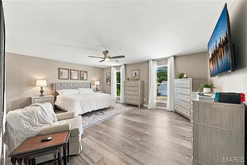 Updated double hung windows, luxury vinyl plank flooring, lighted ceiling fan, large space and neutral decor. — 1417 Plantation Manor Court, St Peters, MO 63303