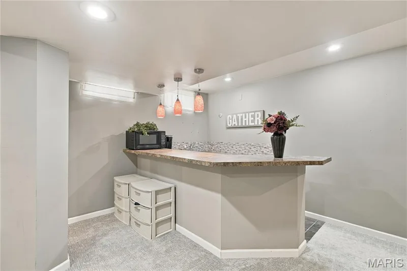 Wet bar with bar height seating and under counter refrigerator. — 1417 Plantation Manor Court, St Peters, MO 63303