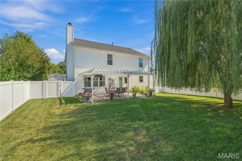 Back yard is lush, white vinyl privacy fence and sprinkler system. — 1417 Plantation Manor Court, St Peters, MO 63303