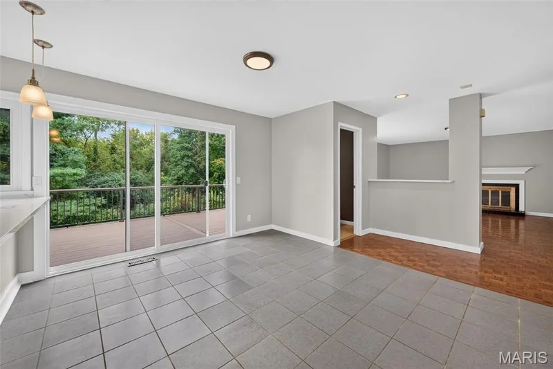 Huge breakfast area features with sliding glass door leading to an outdoor deck, recessed lighting, tile flooring, and half wall partition. — 231 Renaldo Drive, Chesterfield, MO 63017