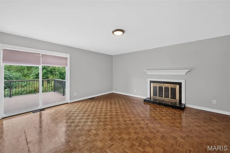 Wood-finish parquet flooring and sliding glass door leading to the outdoor deck. — 231 Renaldo Drive, Chesterfield, MO 63017