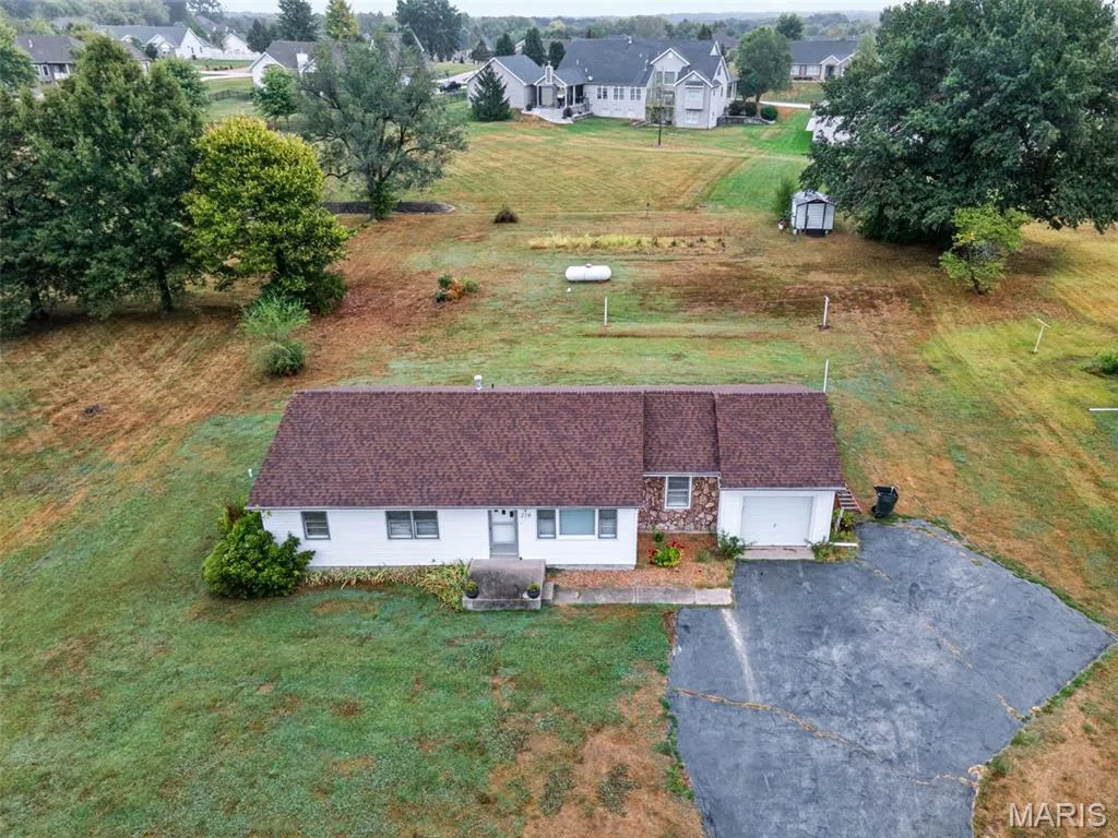 Spacious lot with a generous yard, extra parking, and plenty of room to make it your own! — 219 Mexico Road, Wentzville, MO 63385