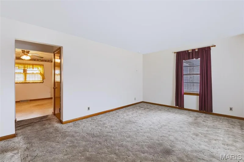 Living Room off the Front Entry - HARDWOOD FLOORING under the Carpet - See Virtually Staged photo for Inspiration.  One bedroom has the carpet removed for reference. — 219 Mexico Road, Wentzville, MO 63385