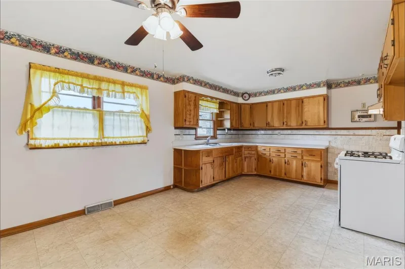 Plenty of room to cook, gather and make it your own! This spacious kitchen offers abundant cabinetry, counter space and a large eat-in area. — 219 Mexico Road, Wentzville, MO 63385