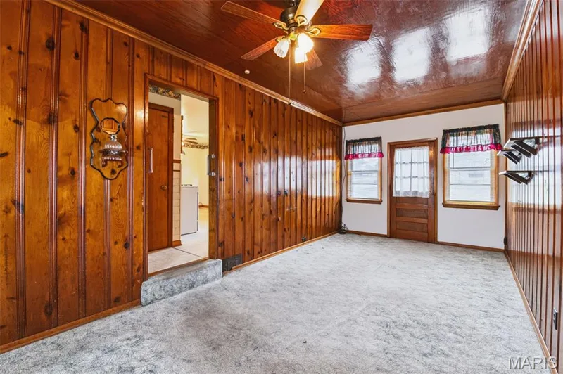 A little retro charm! Spacious family room with warm wood accents and plenty of room for comfortable everyday living. — 219 Mexico Road, Wentzville, MO 63385