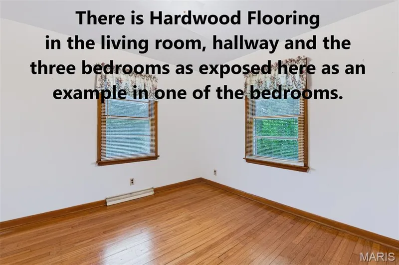 Hardwood Flooring is under the carpeting in the living room, hallway and bedrooms as shown and exposed in one of the bedrooms. — 219 Mexico Road, Wentzville, MO 63385