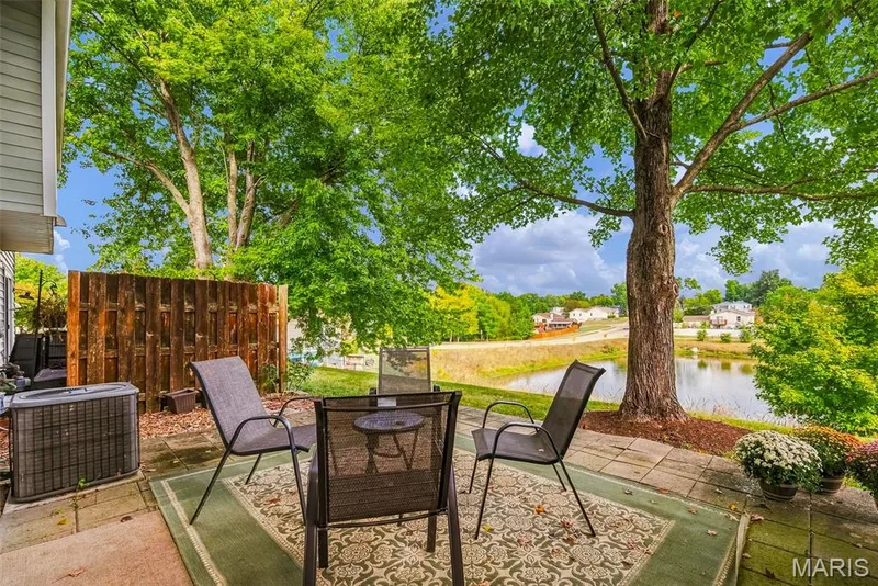 Patio with Privacy Fencing and View of Adjacent Neighborhood Pond — 3248 Meadow Trail Drive #75, St Peters, MO 63376