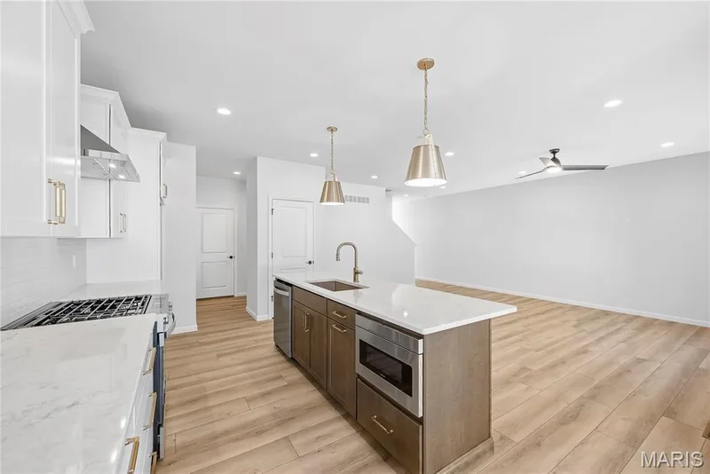 Kitchen Island with Quartz Countertops, Drawer Microwave, Dishwasher, Karran Sink and On-Trend Pendant Lighting — 53 Pheasant Ring Drive, St Peters, MO 63376