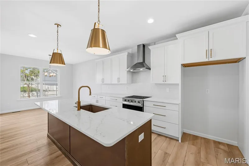 42 inch Shaker Style Cabinets with Crown Molding, Quartz Countertops, Stainless Steel Appliances and Tile Backsplash in Kitchen — 53 Pheasant Ring Drive, St Peters, MO 63376
