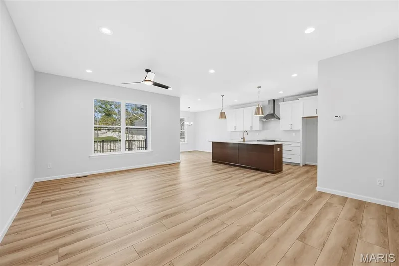 Family Room and Kitchen with 9 Foot Ceilings and Luxury Vinyl Plank Flooring — 53 Pheasant Ring Drive, St Peters, MO 63376