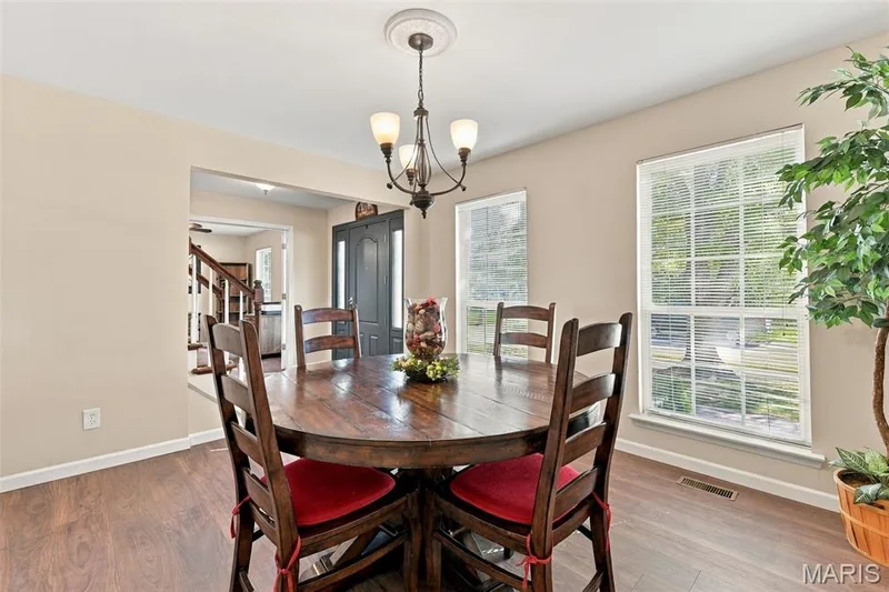 Dining room with newer luxury vinyl flooring off entry and kitchen — 5872 Wellington Farm Drive, St Charles, MO 63304
