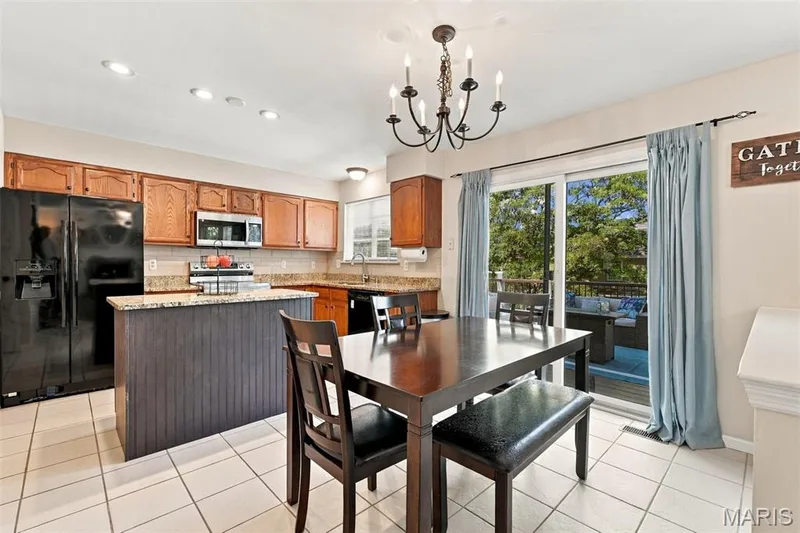 kitchen with new slider to spacious new deck and fenced back yard — 5872 Wellington Farm Drive, St Charles, MO 63304