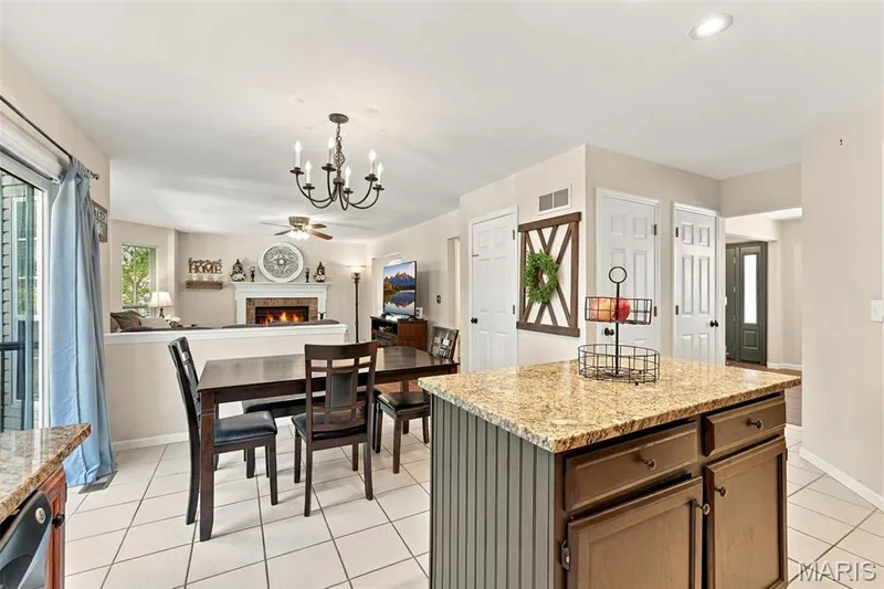 Prep island and breakfast room open to the family room — 5872 Wellington Farm Drive, St Charles, MO 63304