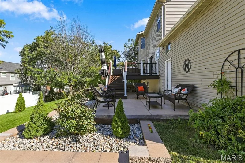 New patio from upper level deck, beautiful stamped concrete and new landscaping, even an out door restroom — 5872 Wellington Farm Drive, St Charles, MO 63304